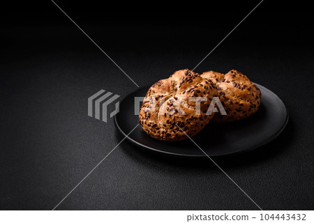 Delicious freshly baked crispy bun or kaiser roll with sesame seeds 104443432