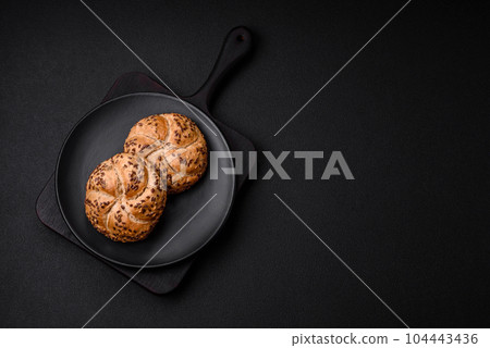 Delicious freshly baked crispy bun or kaiser roll with sesame seeds Delicious freshly baked crispy bun or kaiser roll with sesame seeds 104443436