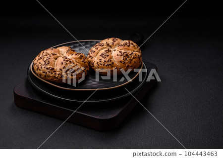 Delicious freshly baked crispy bun or kaiser roll with sesame seeds Delicious freshly baked crispy bun or kaiser roll with sesame seeds 104443463