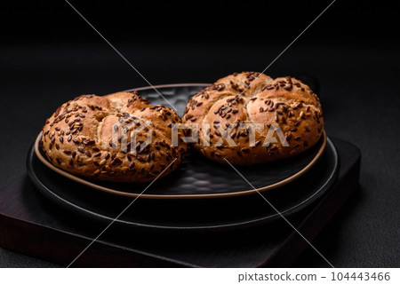 Delicious freshly baked crispy bun or kaiser roll with sesame seeds Delicious freshly baked crispy bun or kaiser roll with sesame seeds 104443466