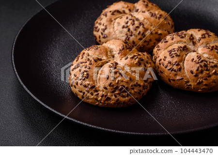 Delicious freshly baked crispy bun or kaiser roll with sesame seeds 104443470