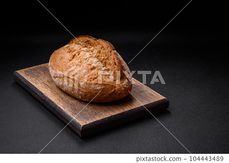 Delicious fresh baked crispy loaf of bread with seeds and grains 104443489