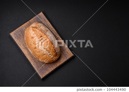 Delicious fresh baked crispy loaf of bread with seeds and grains 104443490