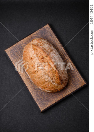 Delicious fresh baked crispy loaf of bread with seeds and grains 104443491