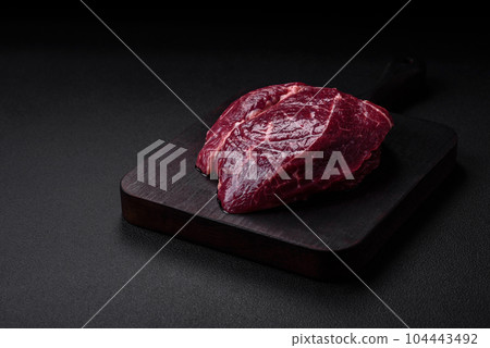 Fresh raw beef steak with salt, spices and herbs Fresh raw beef steak with salt, spices and herbs 104443492