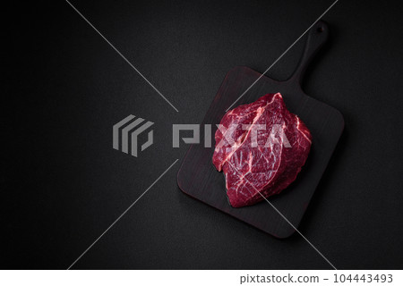 Fresh raw beef steak with salt, spices and herbs 104443493