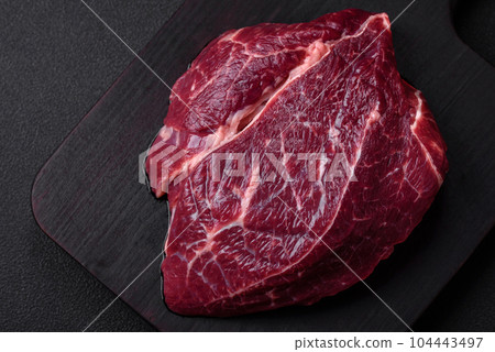 Fresh raw beef steak with salt, spices and herbs 104443497