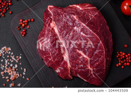 Fresh raw beef steak with salt, spices and herbs Fresh raw beef steak with salt, spices and herbs 104443509