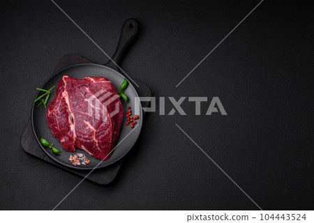 Fresh raw beef steak with salt, spices and herbs 104443524