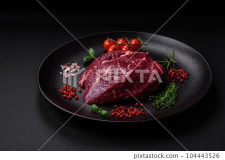 Fresh raw beef steak with salt, spices and herbs Fresh raw beef steak with salt, spices and herbs 104443526