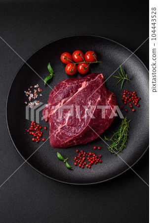 Fresh raw beef steak with salt, spices and herbs 104443528