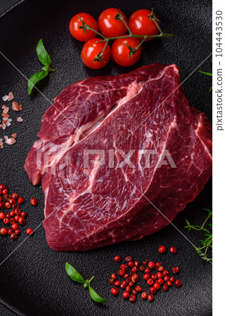 Fresh raw beef steak with salt, spices and herbs 104443530