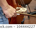 Real life young music students during rehearsals. Musical instruments and music stand with stave. 104444227