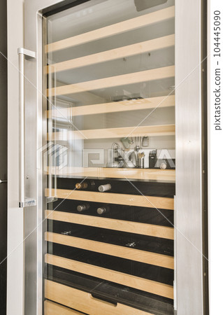 a modern bathroom with black and white stripes on the walls, wood trim around the edges and mirror in the door 104445090