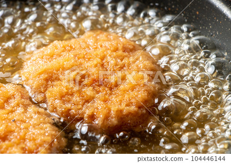 Leftover fried food (tonkatsu) remake cooking scene. Boil in a frying pan with dashi stock to bind the egg. Leftover fried food (tonkatsu) remake cooking scene. Boil in a frying pan with dashi stock to bind the egg. 104446144