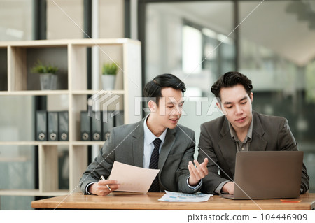 Group of business man discussion and brainstorming, bookkeeping audit graph and chart documents at desk, teamwork concept. 104446909