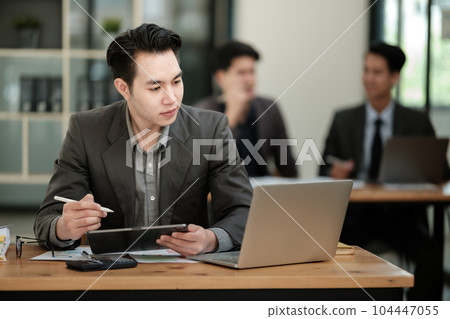 Handsome cheerful asian man executive business man at the workspace office Handsome cheerful asian man executive business man at the workspace office 104447055