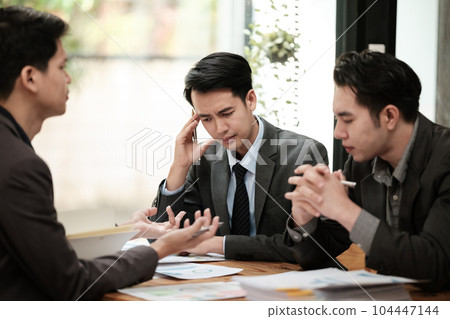 Group of business man discussion and brainstorming, bookkeeping audit graph and chart documents at desk, teamwork concept. 104447144
