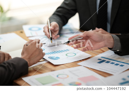 Close up group of business men and woman discussion and brainstorming, bookkeeping audit graph and chart documents at desk, teamwork concept. Close up group of business men and woman discussion and brainstorming, bookkeeping audit graph and chart documents at desk, teamwork concept. 104447192
