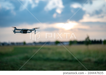 Drone hovering above the skyline as dusk approaches.  104447635