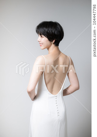 Asian women's beautiful back and shoulder blades Illustration of a beautiful woman looking back Copy space on the left Vertical 104447798