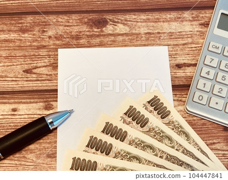 Money, memo paper and calculator (with copy space) 104447841