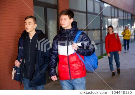 Two teenagers go on a street to college 104448180