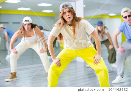 Teen girl in cap dances hip hop dances Teen girl in cap dances hip hop dances 104448382