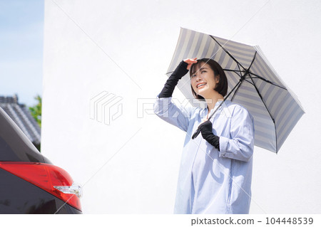 Photo of a woman holding a parasol Photo of a woman holding a parasol 104448539