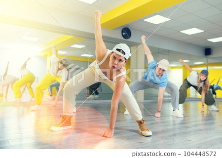 Young girl in cap dancing hip hop 104448572