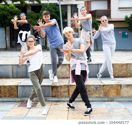 Group of teenagers performing street dance outdoors Group of teenagers performing street dance outdoors 104448577