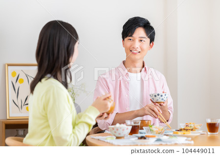 Young couple eating breakfast Young couple eating breakfast 104449011