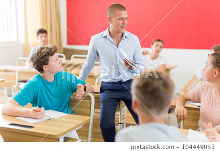 Young students sitting at desks in classroom Young students sitting at desks in classroom 104449031