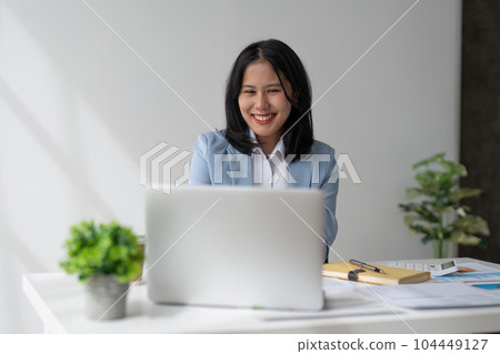 businesswoman work with laptop, writing notes on colorful sticky papers in office 104449127
