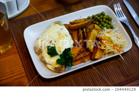 French style meat with potato wedges and vegetables French style meat with potato wedges and vegetables 104449129