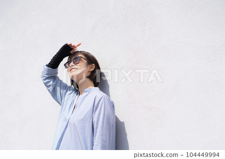 Portrait of a woman doing sun protection Portrait of a woman doing sun protection 104449994
