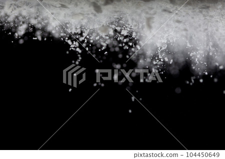 Tapioca starch flour fly explosion, White powder tapioca starch fall down in air. Seasoning flour powder is element material. Eyeshadow crush make up. Black background Isolated selective focus blur 104450649