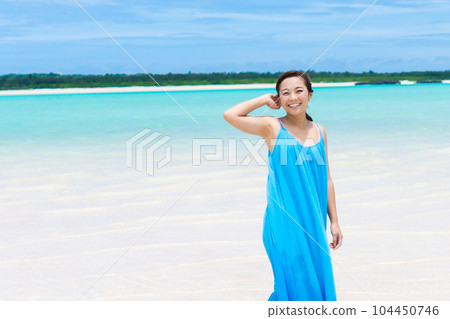 Young woman smiling on the beach 104450746