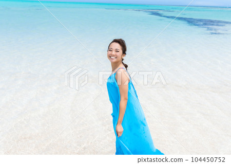 Young woman smiling on beautiful sandy beach 104450752