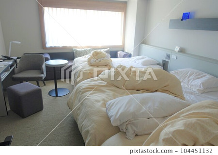 Messy hotel bed at checkout Messy hotel bed at checkout 104451132