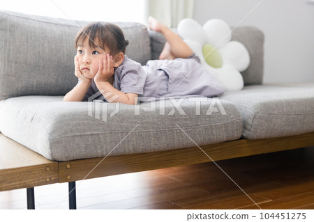Toddler relaxing in the living room Toddler relaxing in the living room 104451275