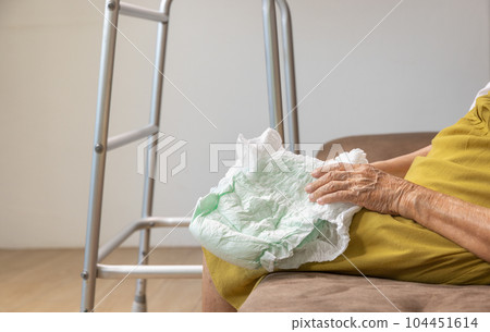 Urinary Incontinence in elderly and changing diaper 104451614