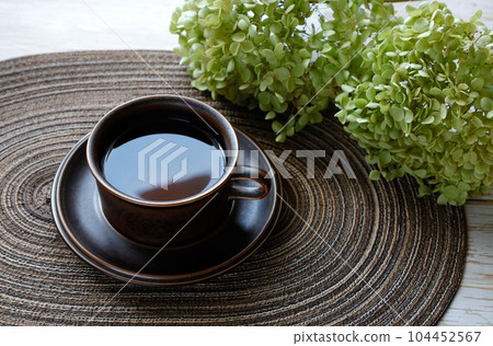 Dried hydrangea (Annabelle) flowers and black tea in an Arabic cup Dried hydrangea (Annabelle) flowers and black tea in an Arabic cup 104452567