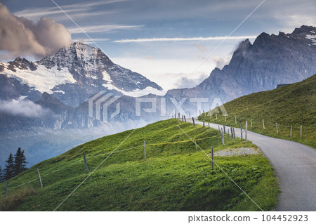 Snowcapped Bernese Swiss alps and mountain road in Murren, Switzerland 104452923