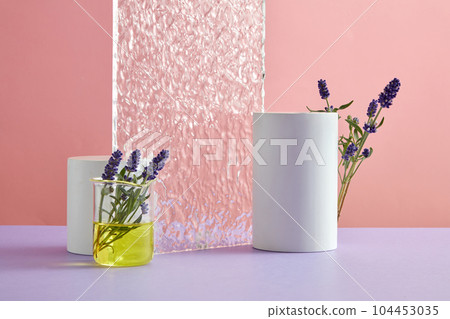 Minimal abstract background for cosmetic presentation with lavender concept. Fresh lavender, cylinder podiums and acrylic sheet decorated on a pink background. Front view Minimal abstract background for cosmetic presentation with lavender concept. Fresh lavender, cylinder podiums and acrylic sheet decorated on a pink background. Front view 104453035