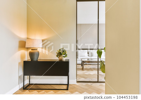 a living room with wood flooring and an open door leading to the outside patio, which has been used for several years 104453198