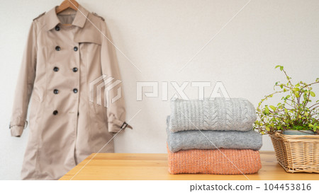 Folded sweater and trench coat | Laundry / change of clothes image Folded sweater and trench coat | Laundry / change of clothes image 104453816