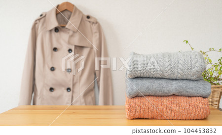 Folded sweater and trench coat | Laundry / change of clothes image 104453832