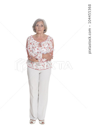 Full length senior woman posing isolated on white background Full length senior woman posing isolated on white background 104455368