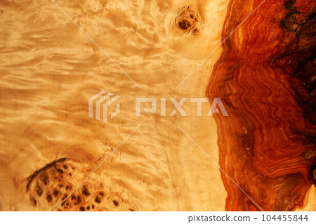 The texture of old light wood with stain and transparent epoxy resin in cracks. Beautiful modern wooden background with resin. High quality photo 104455844